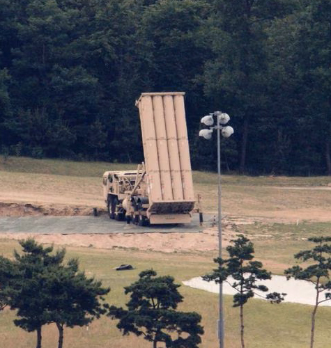 Truck with equipment lifted as if to fire a missile